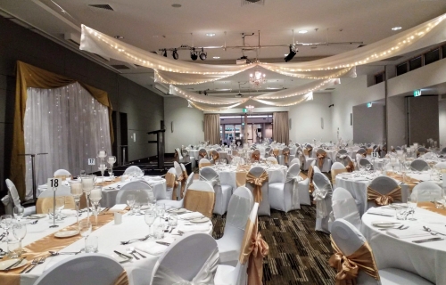 Star ceiling canopy crystal chandeliers chair covers gold bows Pacific Bay Resort