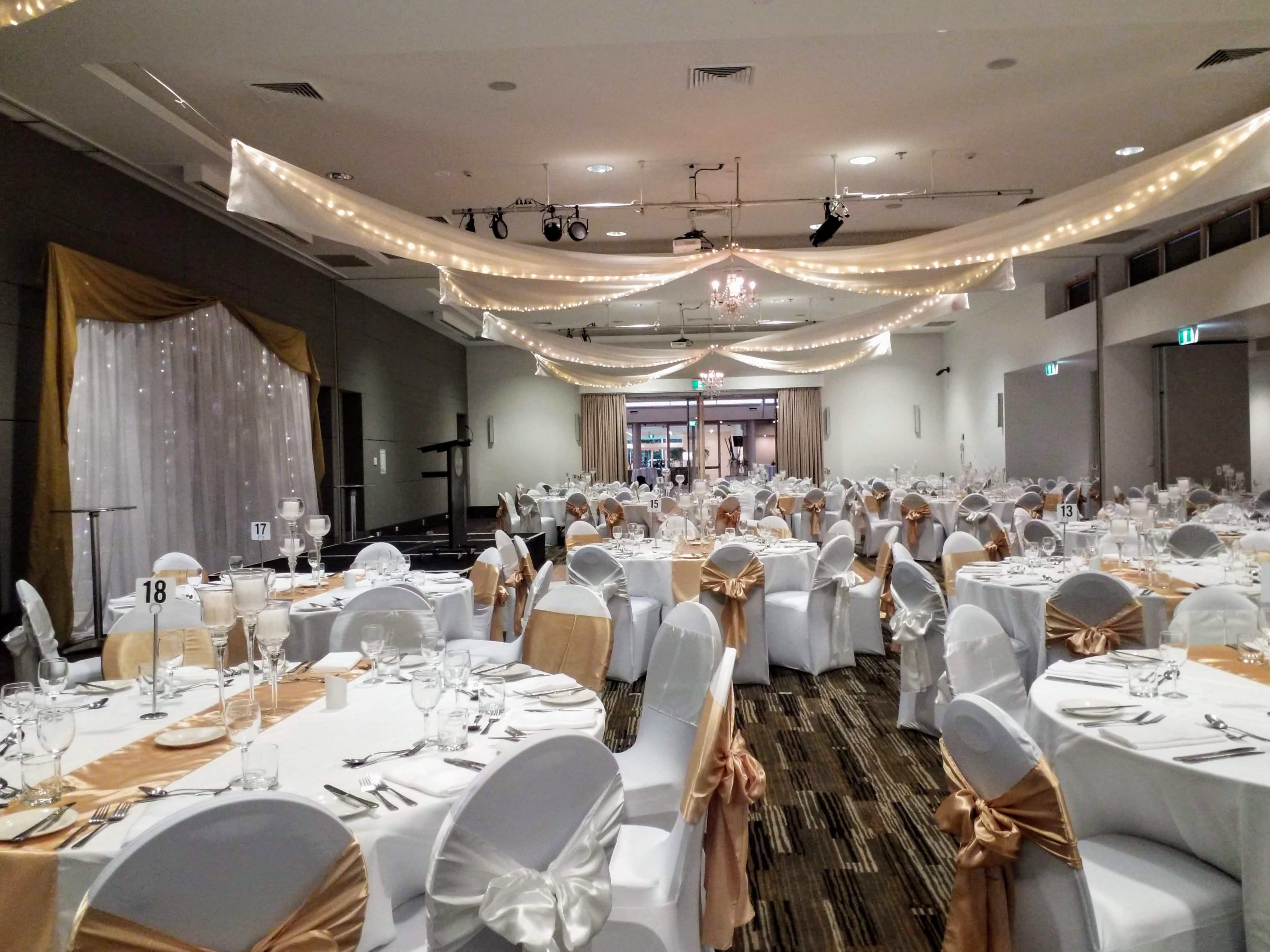 Star ceiling canopy crystal chandeliers chair covers gold bows Pacific Bay Resort