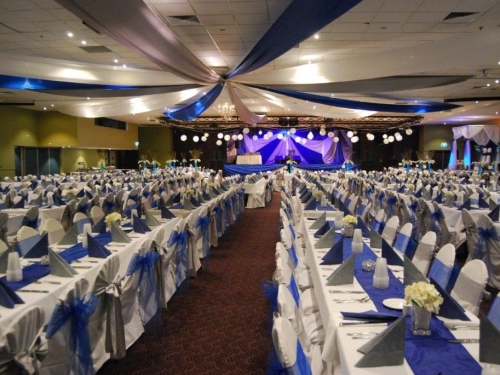 Star ceiling canopy royal blue bows long tables  - Grand Auditorium Cex