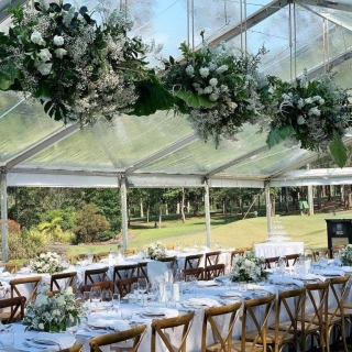 Marquee ceiling canopy fairy lights + fresh floral arrangements + brown Hampton chairs