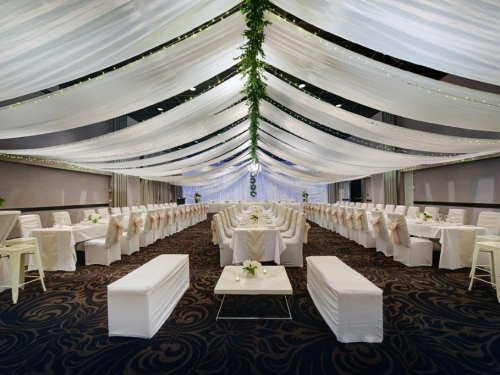 Long white tables greenery spine wreaths Opal Cove Ballroom