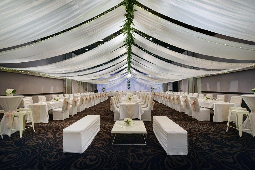 Long white tables greenery spine wreaths Opal Cove Ballroom
