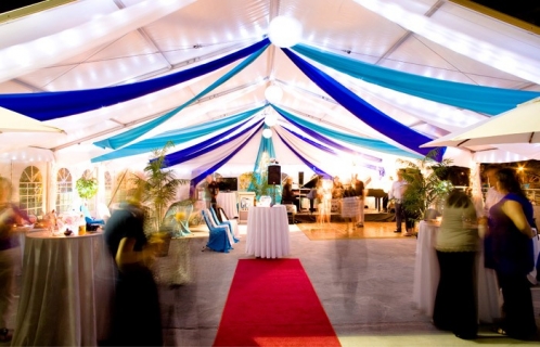 Marquee ceiling canopy aqua + royal blue silks + lanterns, red carpet