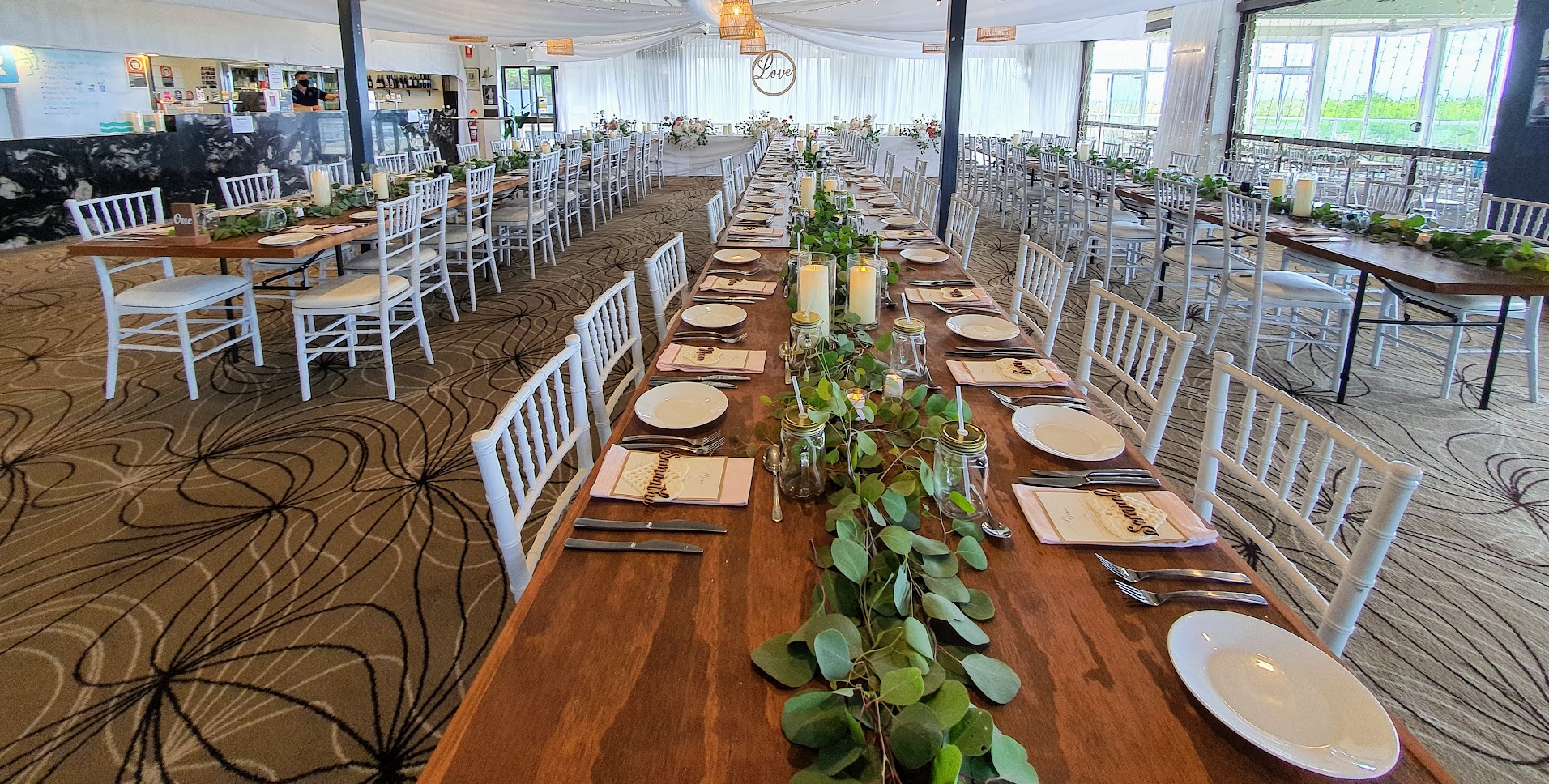 Timber toppers, white Tiffany chairs, glass cylinder vases with remote candle, white satin backdrop, star ceiling ceiling canopy, waterfall fairy lights