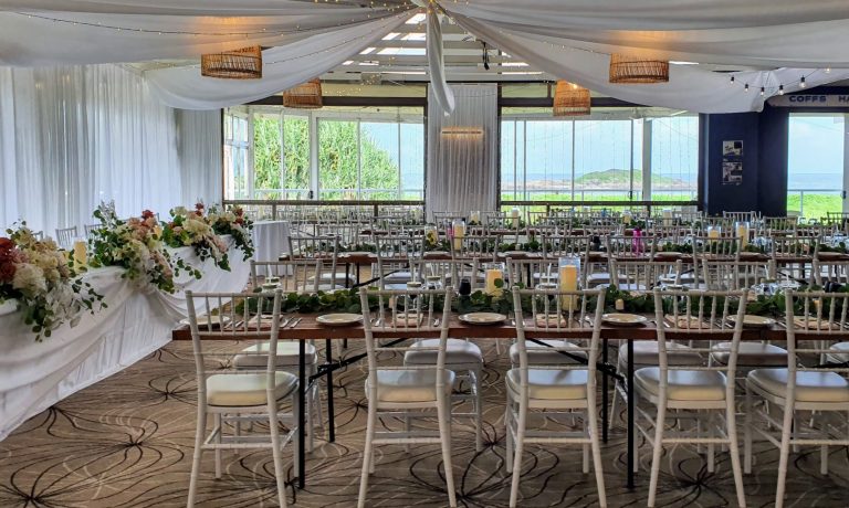 Timber toppers, white Tiffany chairs, glass cylinder vases with remote candle, white satin backdrop, star ceiling ceiling canopy, waterfall fairy lights, (fresh florals not included)