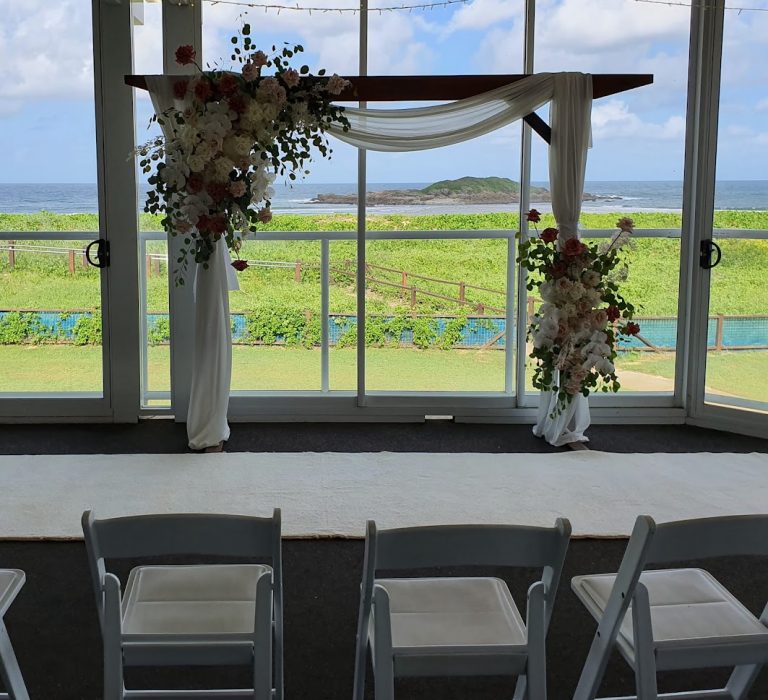 Brown Timber Arbour, soft white silk fabrics, white carpet, Malibu chairs (fresh flowers not included)