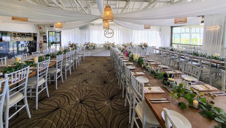 Timber toppers, white Tiffany chairs, glass cylinder vases with remote candle, white satin backdrop, star ceiling ceiling canopy, waterfall fairy lights (fresh florals not included)