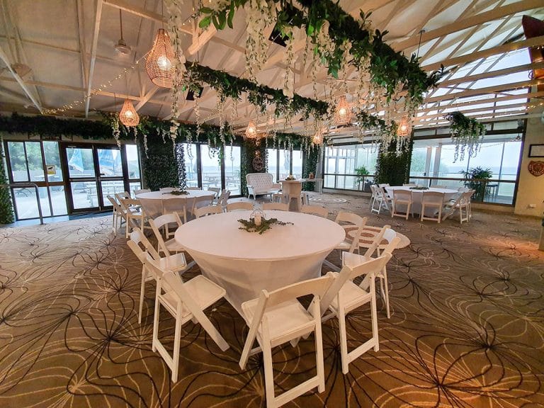 Cocktail style wedding reception backdrop greenery door framing, ceiling canopy wisteria greenery, white timber cocktail hi dry bars