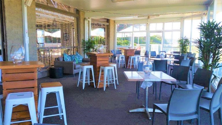 Cocktail style enclosed veranda ,Hi Dry Bars Brown + 4 timber top white stools