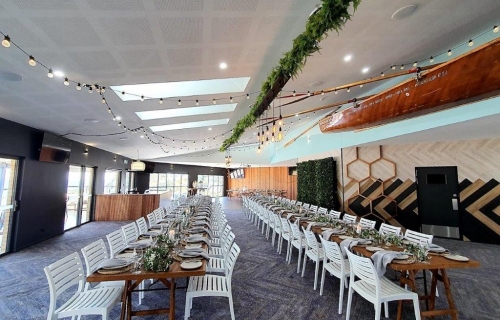 Woolgoolga surf  ceiling canopy, fern greenery ,festoon lighting. Edison chandeliers. photo booth greenery